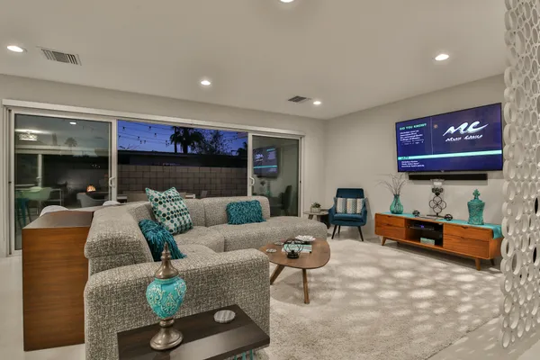 a living room with furniture and a flat screen tv