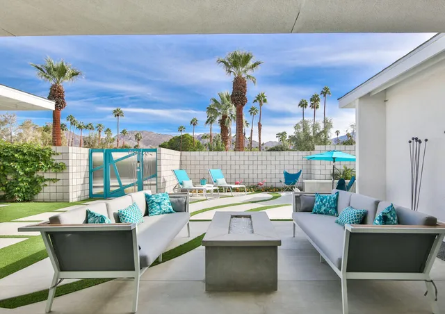 a large white kitchen with a large window and stainless steel appliances