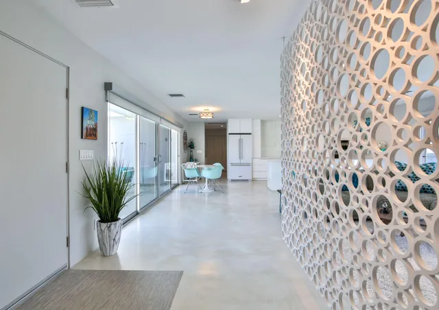 a living room with furniture and kitchen view