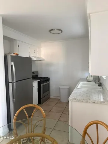 a kitchen with a refrigerator sink and stove