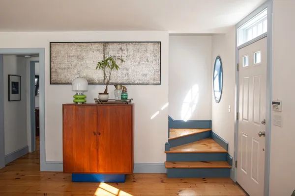 a spacious bedroom with a bed and wooden floor