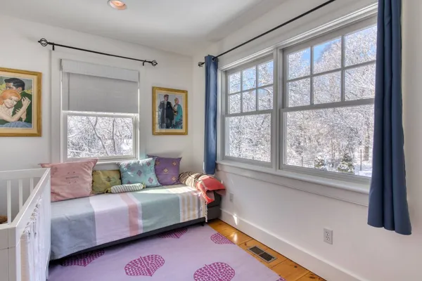 a bed room with a bed and a window