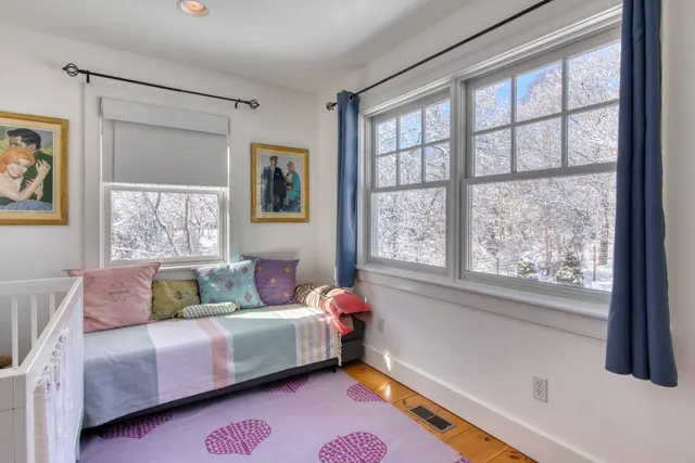 a bed room with a bed and a window