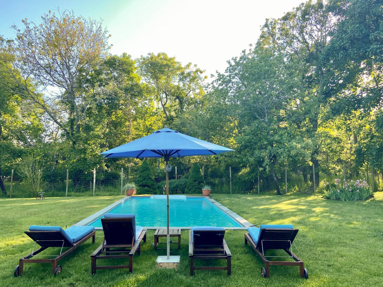 Undisclosed Address Bridgehampton, NY 11932 - Photo 20 of 21 a view of a table and chairs under an umbrella