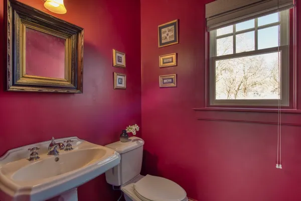 a bathroom with a sink mirror and toilet