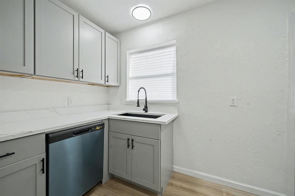 11446 Lippitt Avenue Dallas, TX 75218 - Photo 9 of 26 a kitchen with a sink and cabinets