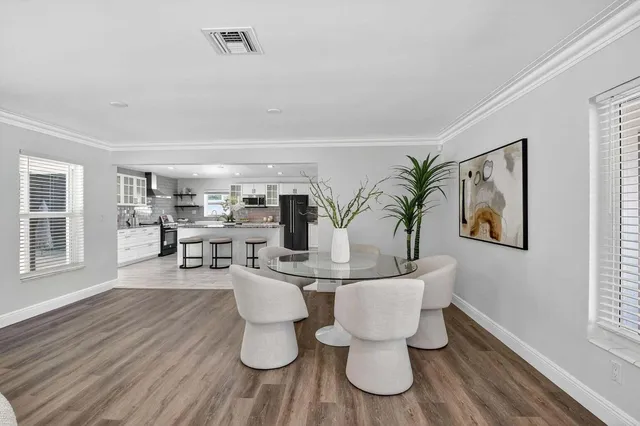 a kitchen with stainless steel appliances kitchen island granite countertop a sink and cabinets