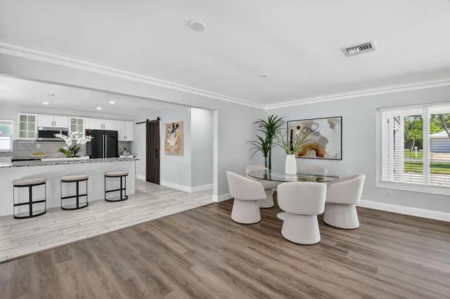 a kitchen with a refrigerator and a wooden cabinets