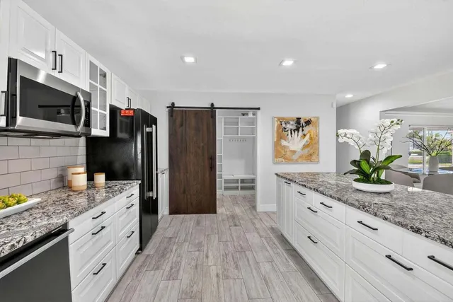 a kitchen with stainless steel appliances granite countertop a stove and a sink