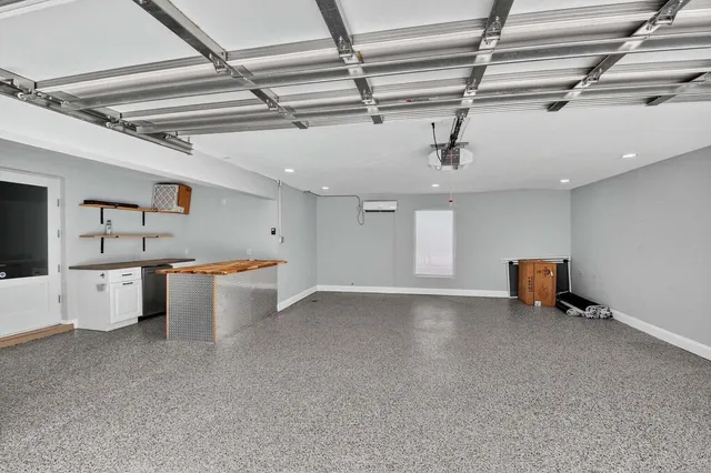 an aerial view of residential houses with outdoor space and trees all around