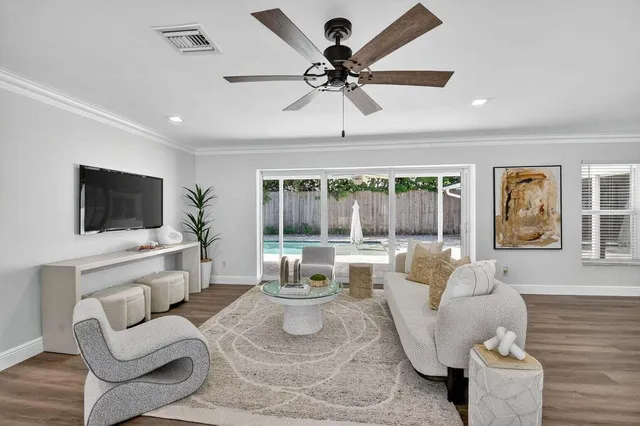 a living room with furniture and wooden floor
