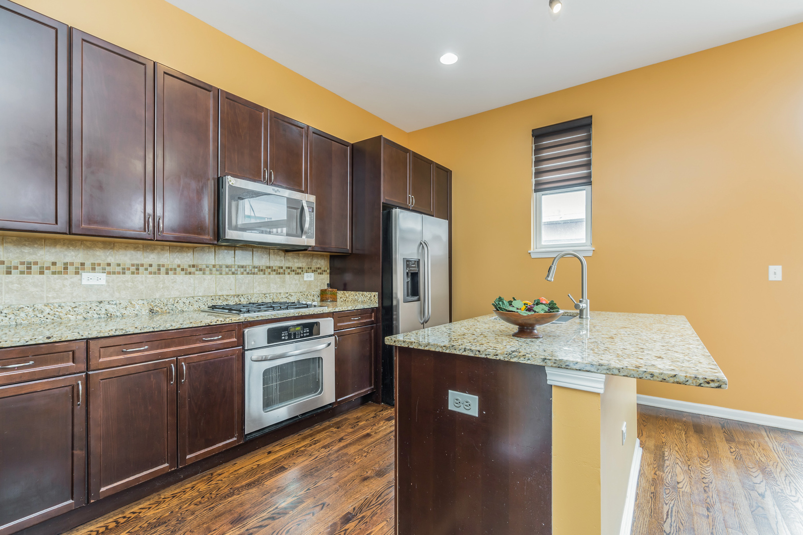 721 West 15th Street Chicago, IL 60607 - Photo 12 of 27 a kitchen with stainless steel appliances granite countertop wooden cabinets a sink and dishwasher