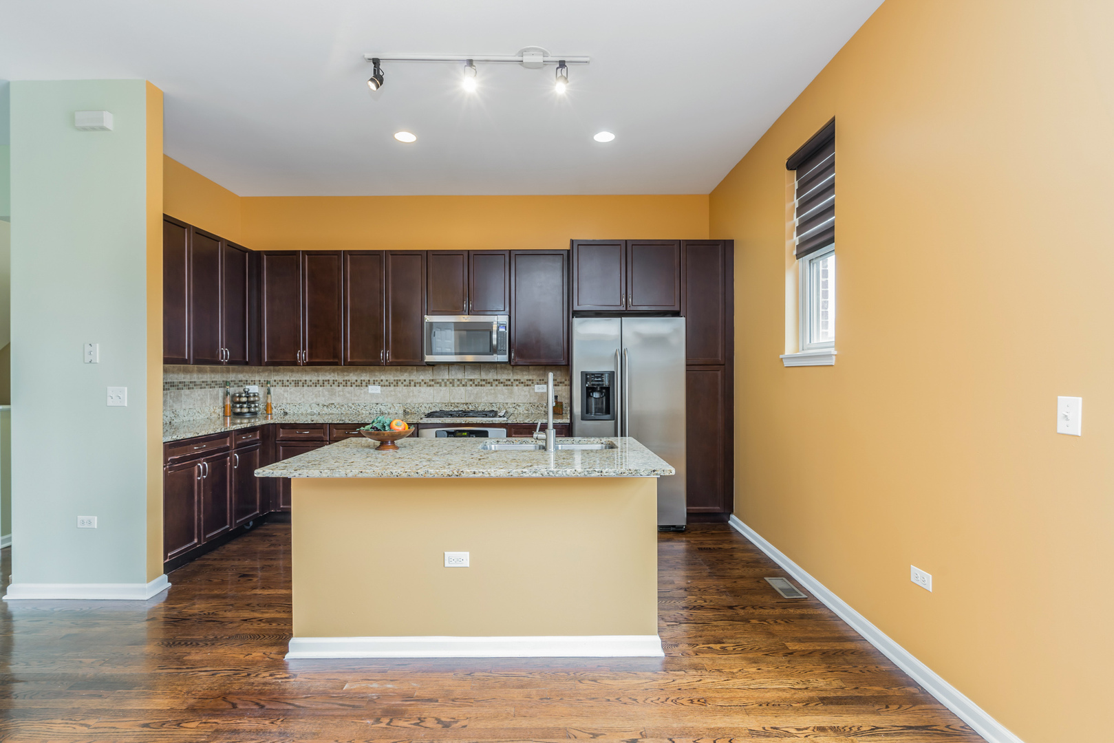 721 West 15th Street Chicago, IL 60607 - Photo 13 of 27 a kitchen with kitchen island a stove a refrigerator a sink dishwasher with a dining table and chairs