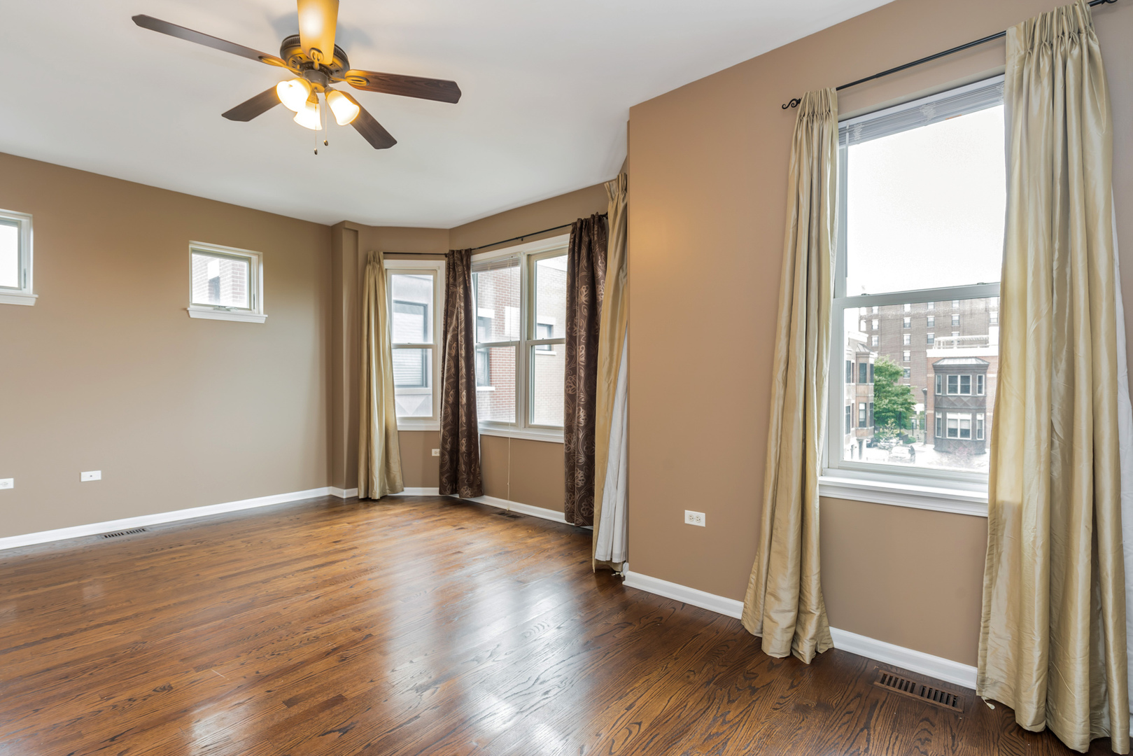 721 West 15th Street Chicago, IL 60607 - Photo 17 of 27 a view of an empty room with a window and wooden floor