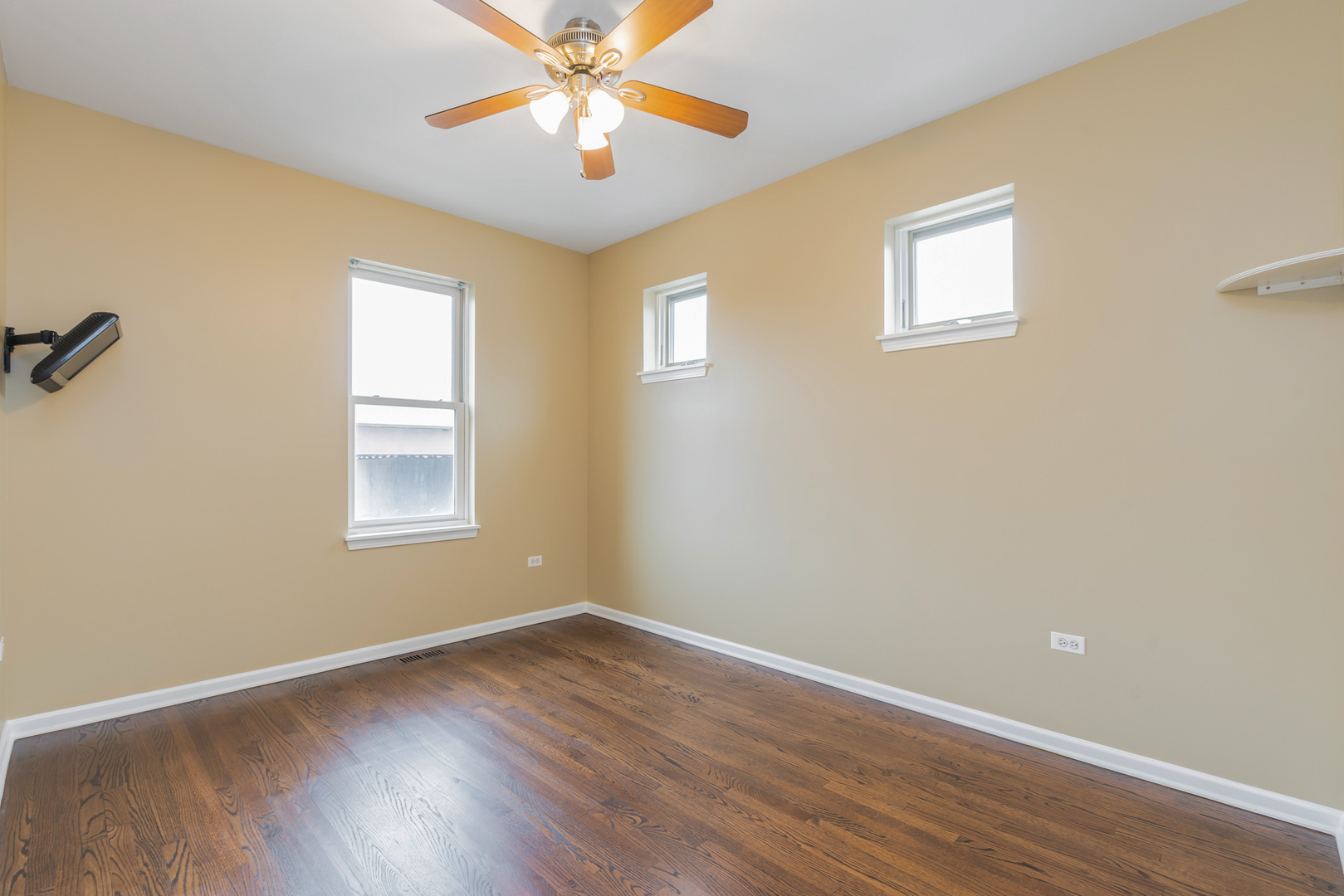 721 West 15th Street Chicago, IL 60607 - Photo 23 of 27 a view of an empty room with wooden floor and a window