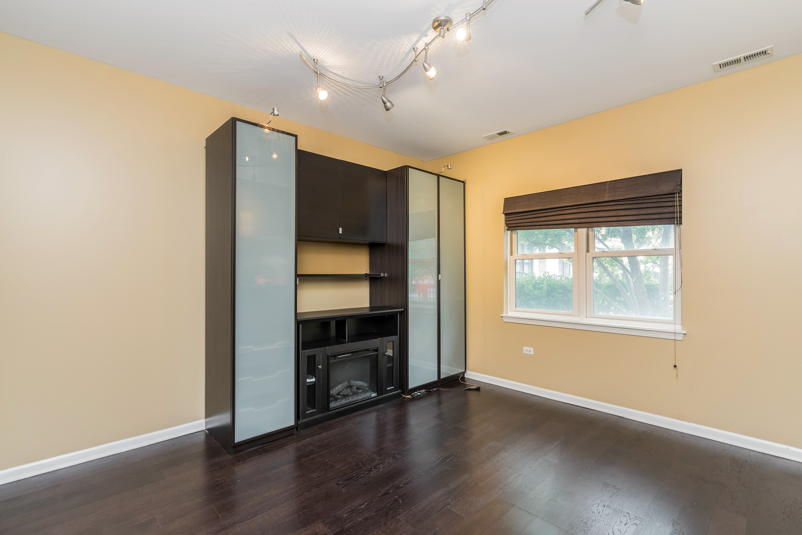 721 West 15th Street Chicago, IL 60607 - Photo 4 of 27 an empty room with wooden floor closet and windows