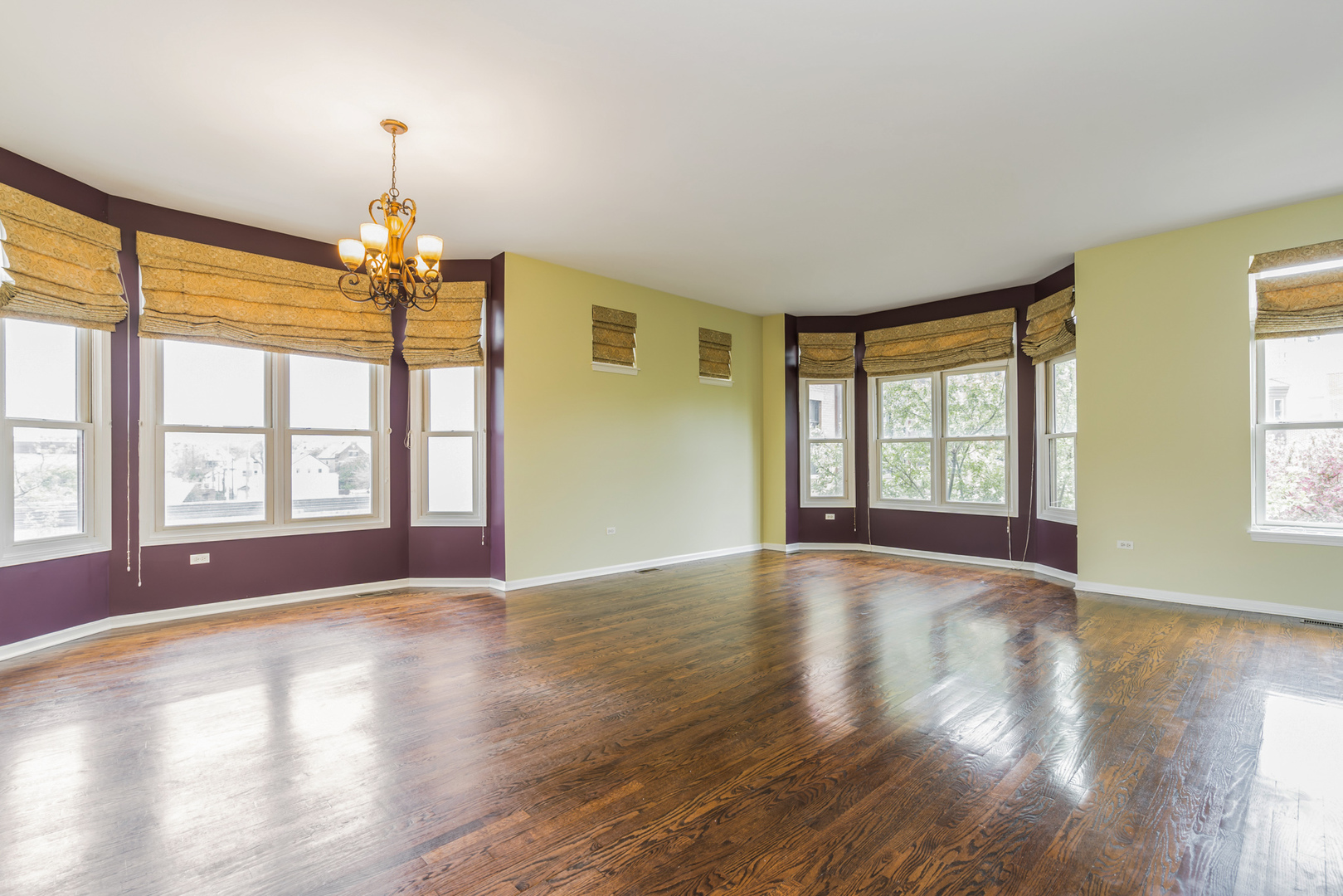 721 West 15th Street Chicago, IL 60607 - Photo 8 of 27 a view of livingroom with window chandelier and wooden floor