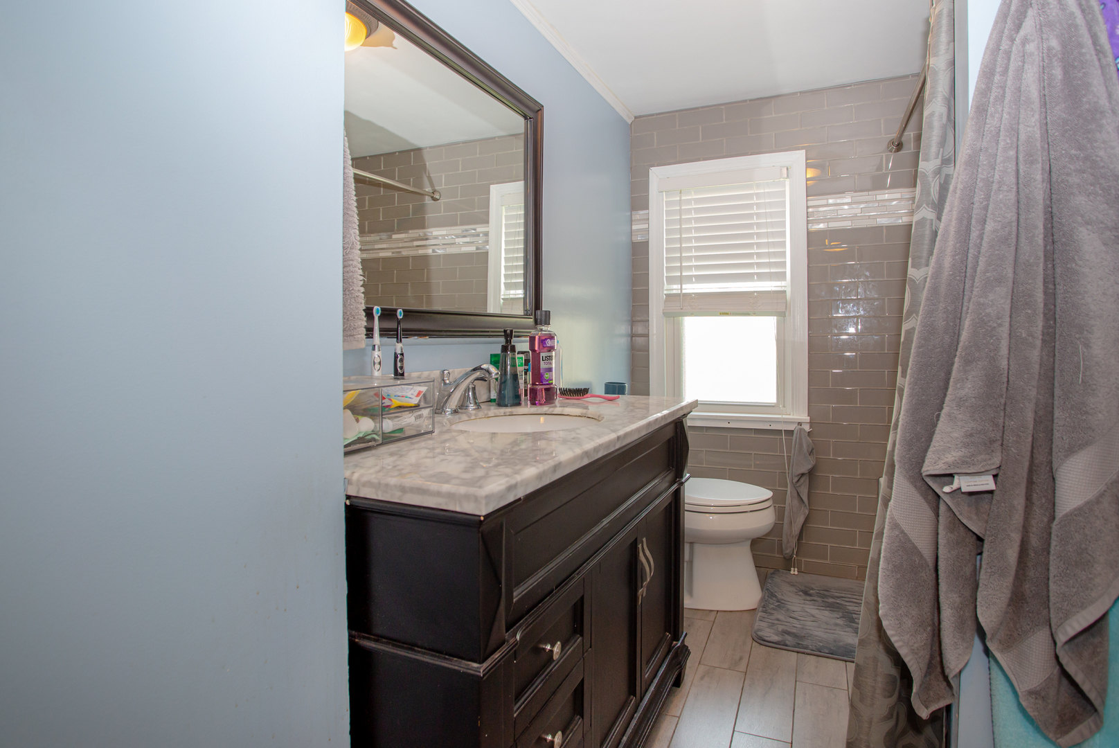 243 Clayton Road Hillside, IL 60162 - Photo 8 of 17 a bathroom with a granite countertop sink toilet and a mirror