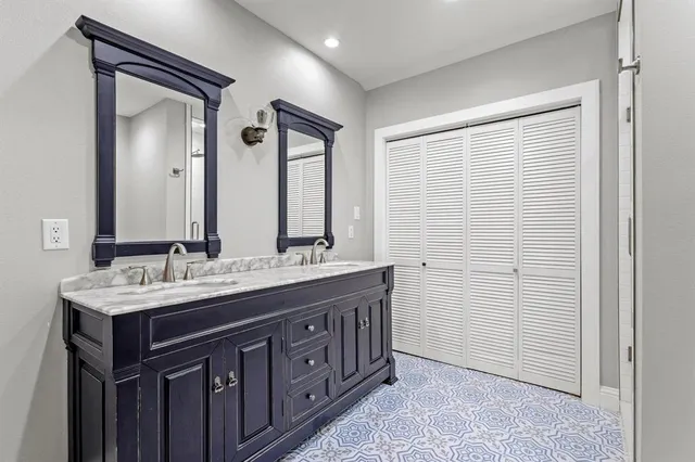 a bathroom with double sink and a mirror