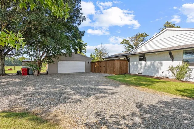 a view of a house with a yard and garage