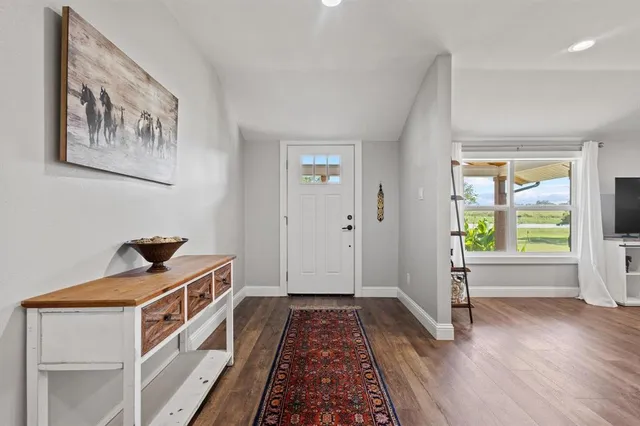 a view of an entryway with wooden floor