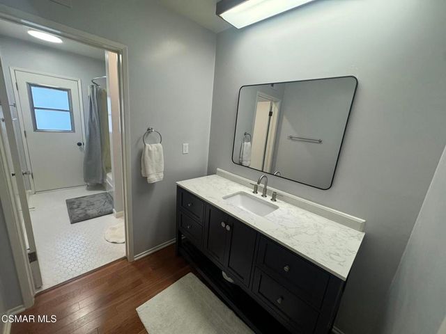 a bathroom with a sink a toilet and mirror