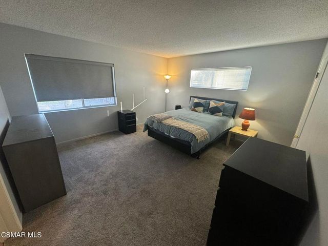 a bedroom with bed and window