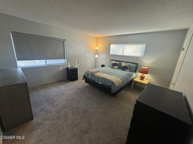 a bedroom with bed and window