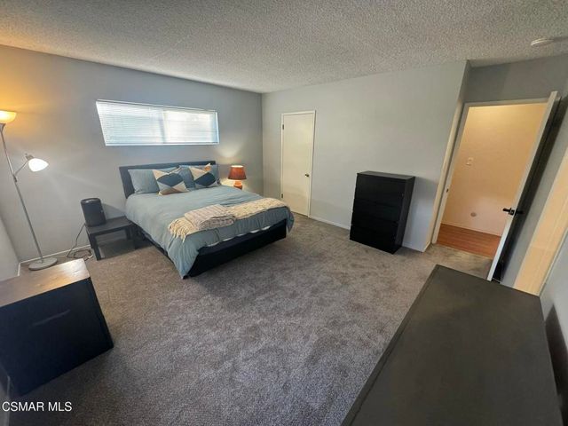 a bedroom with a bed and a television