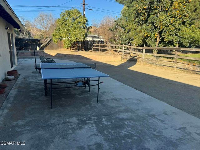 a swimming pool with outdoor seating and yard
