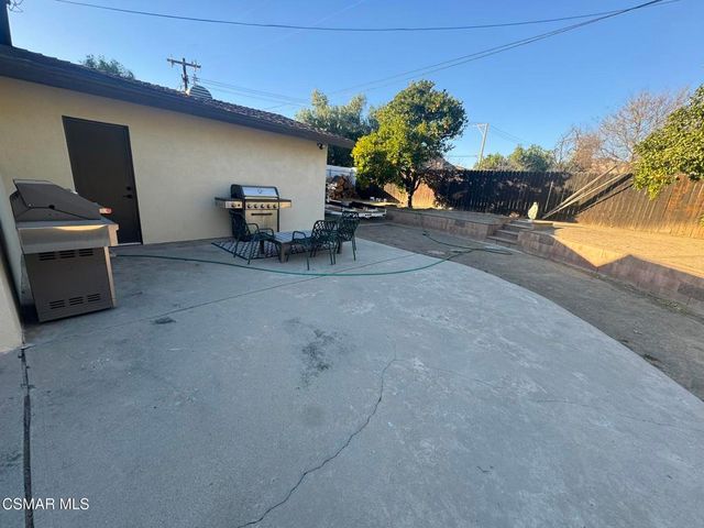a view of a patio with dining table and chairs
