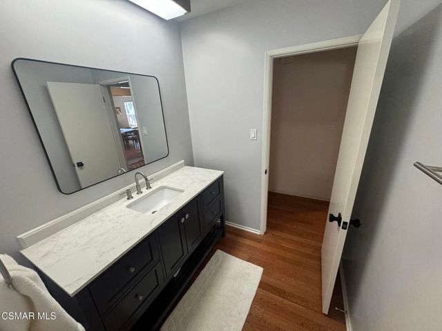 a en suite bathroom with a double vanity sink and a mirror