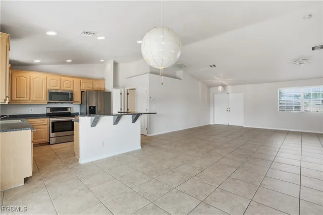 a kitchen with granite countertop white cabinets and a sink