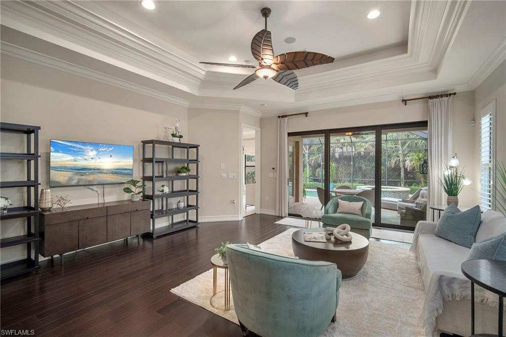 a living room with furniture and a floor to ceiling window