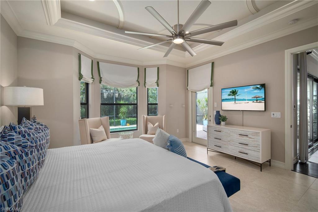 6565 Roma Way Naples, FL 34113 - Photo 12 of 32 a spacious bedroom with a bed and a large window