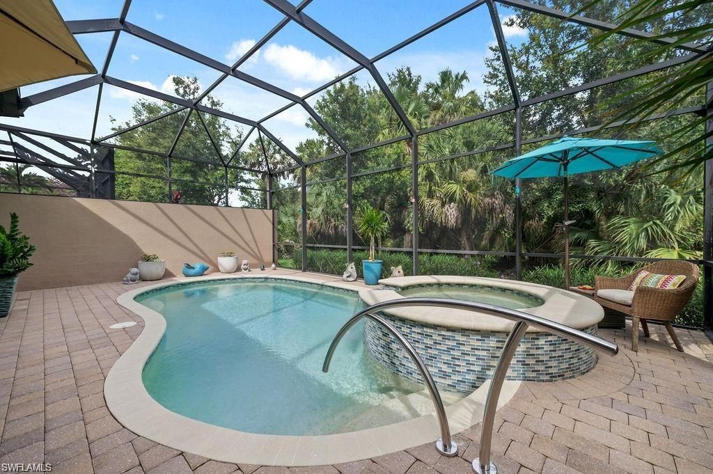 6565 Roma Way Naples, FL 34113 - Photo 22 of 32 a view of a swimming pool with a patio