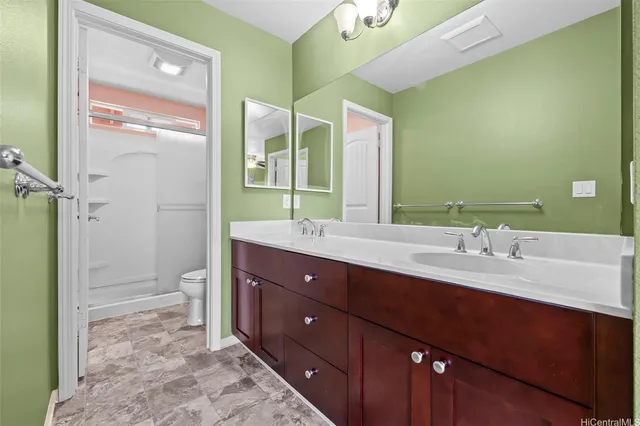 a white toilet sitting next to a bathroom sink