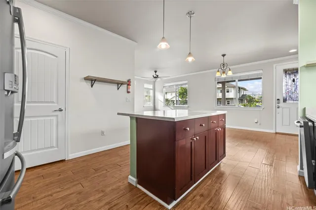a kitchen with wooden floor and window