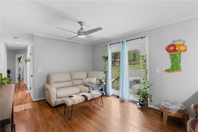 a living room with furniture potted plant and a chandelier