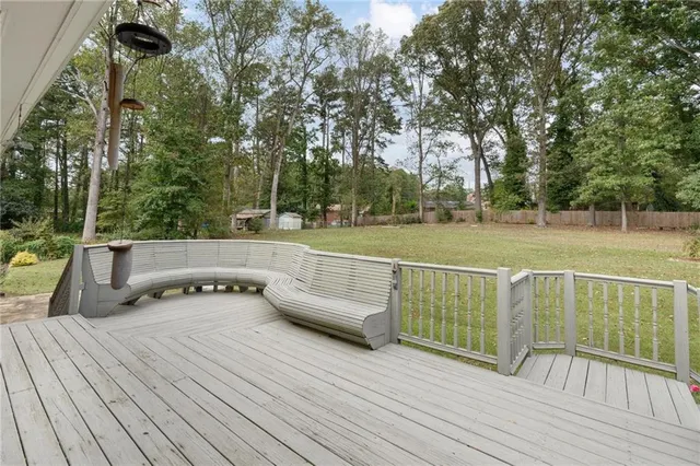a view of a deck with mountain view and wooden floor