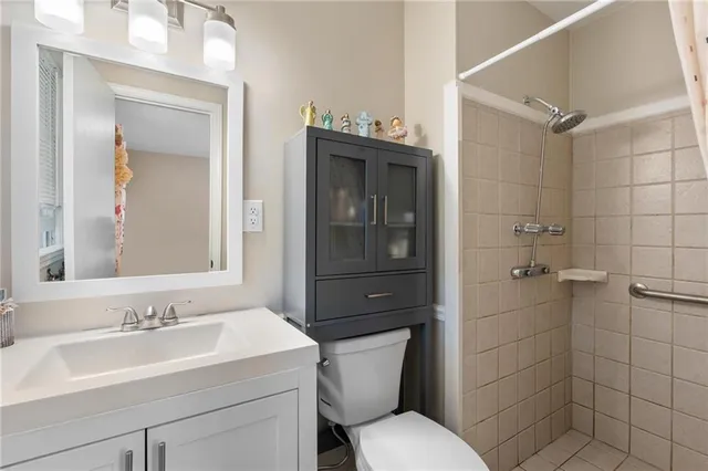 a bathroom with a sink toilet and shower