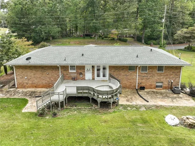 a aerial view of a house with swimming pool and sitting area