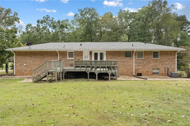a view of a house with a patio and a yard