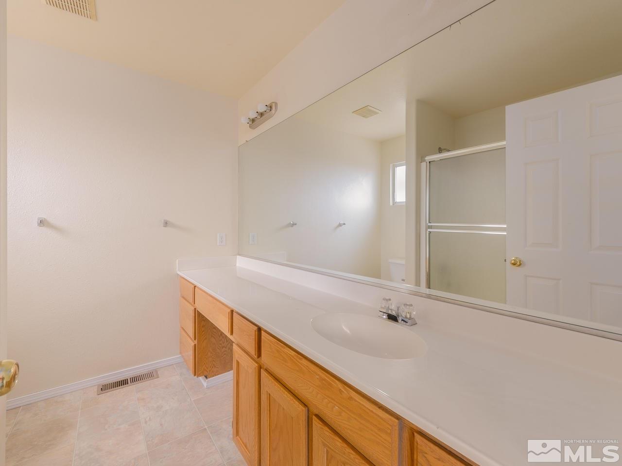 4775 Goodwin Road Sparks, NV 89436 - Photo 8 of 19 a bathroom with a sink and a mirror