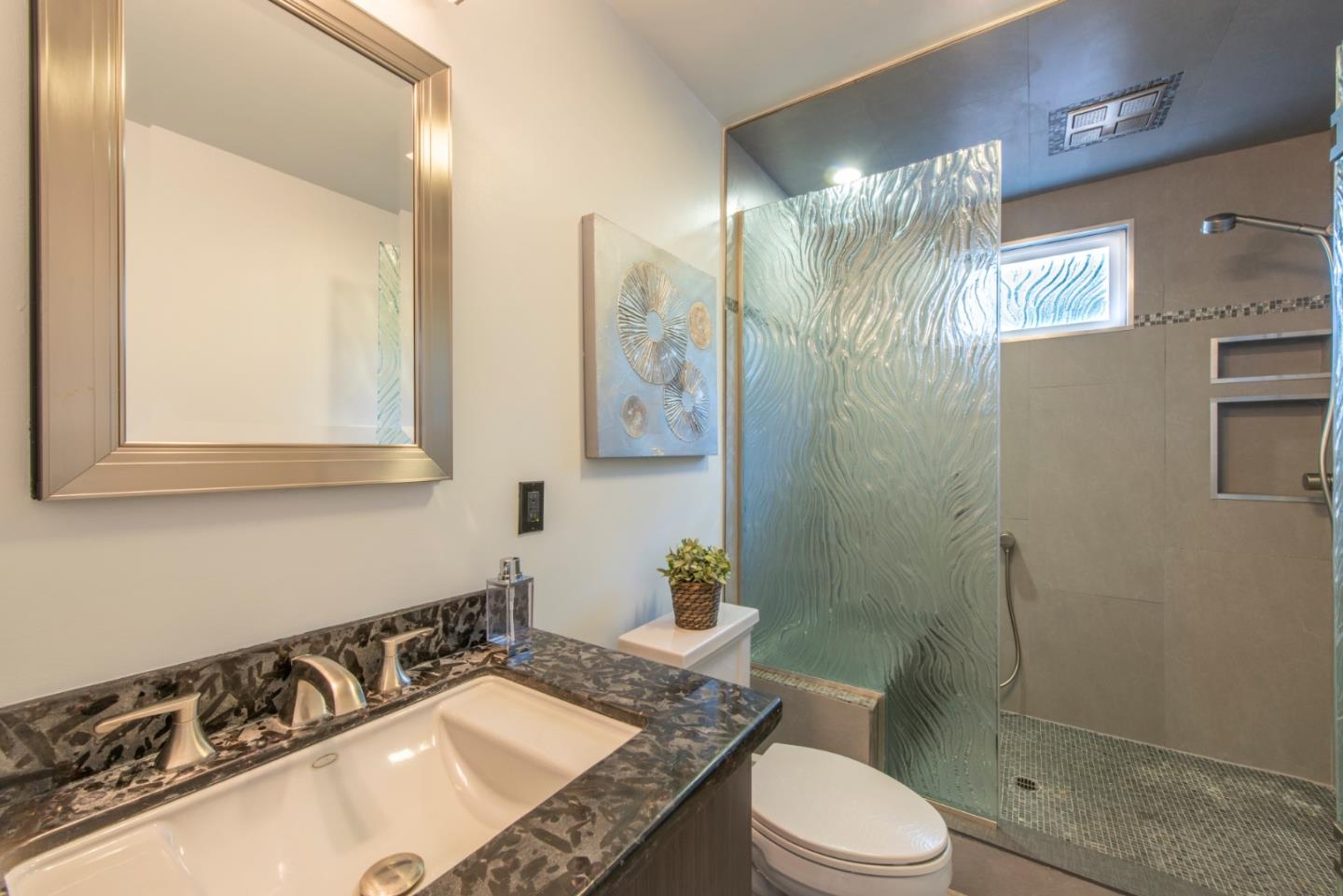 82 Loucks Avenue Los Altos, CA 94022 - Photo 16 of 23 a bathroom with a sink toilet a mirror and shower