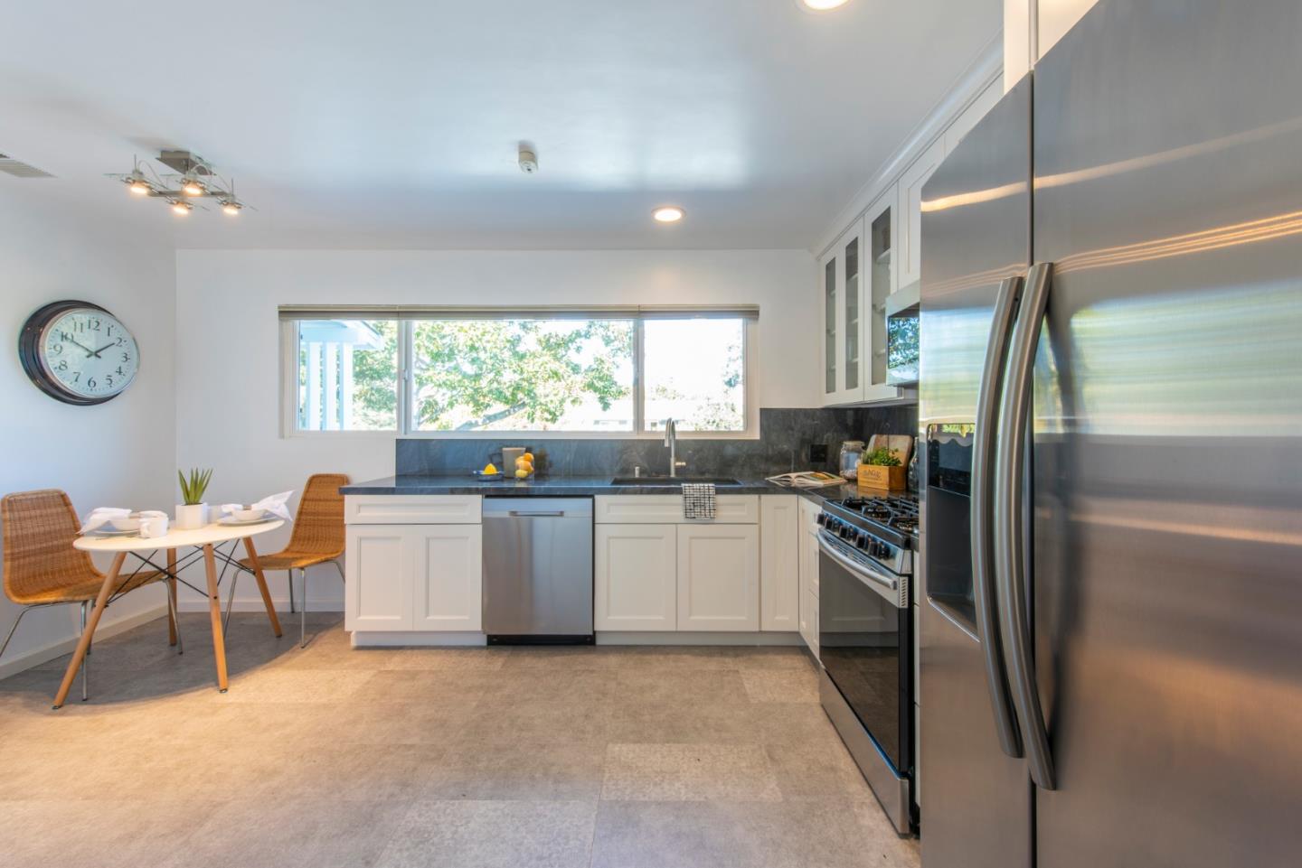 82 Loucks Avenue Los Altos, CA 94022 - Photo 7 of 23 a kitchen with stainless steel appliances granite countertop a refrigerator a sink a stove and white cabinets