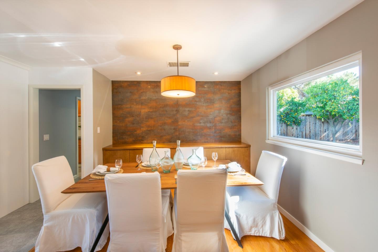 82 Loucks Avenue Los Altos, CA 94022 - Photo 10 of 23 a dining room with furniture a chandelier and wooden floor