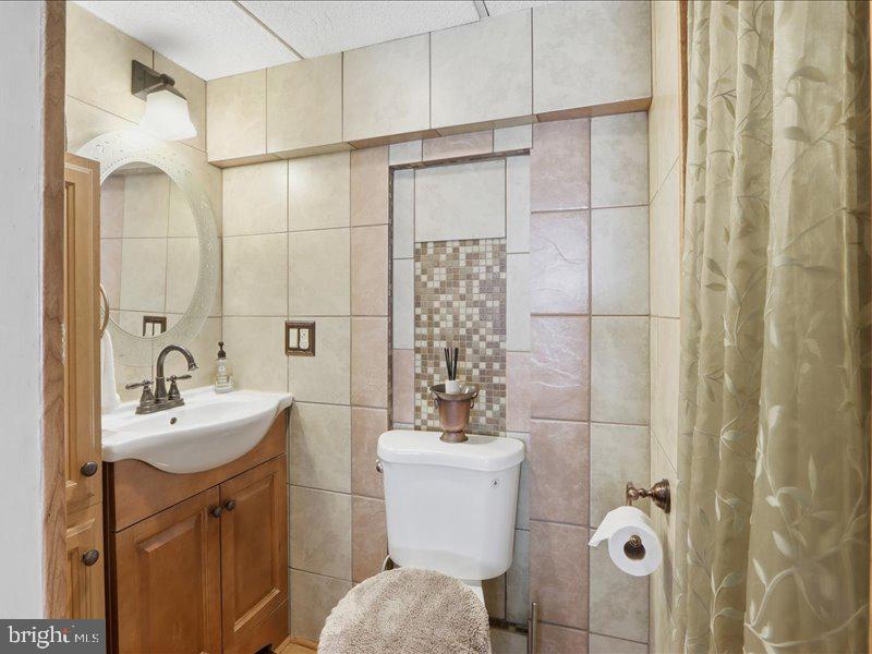 4344 Annapolis Road Halethorpe, MD 21227 - Photo 18 of 35 a bathroom with a sink toilet and shower