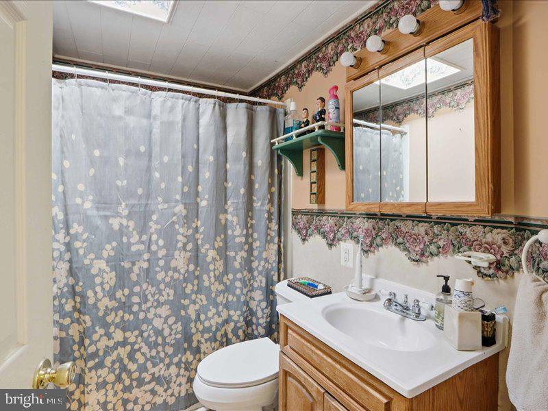 4344 Annapolis Road Halethorpe, MD 21227 - Photo 23 of 35 a bathroom with a sink toilet and shower