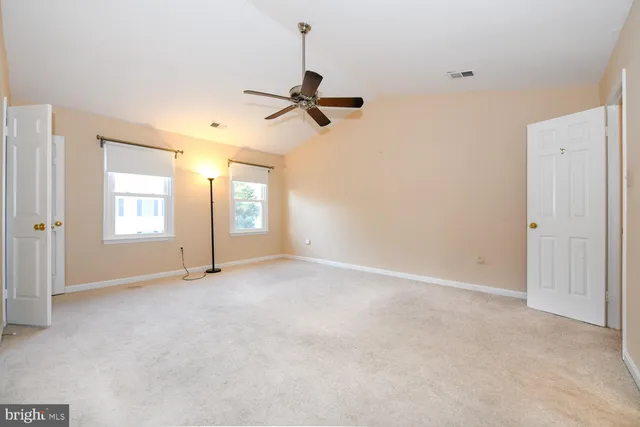 a view of empty room with ceiling fan